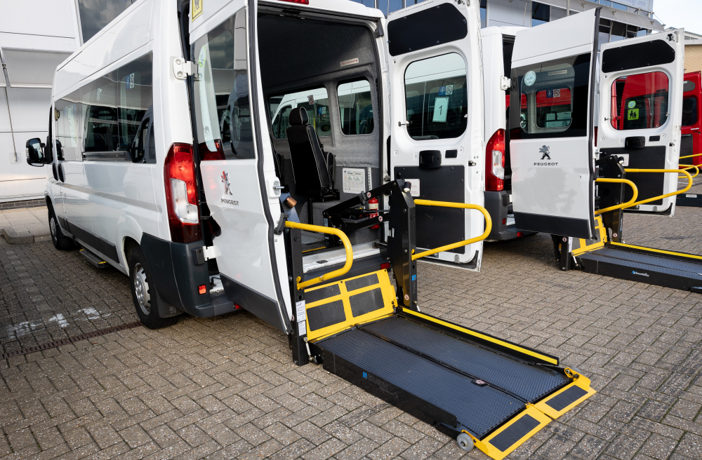 Wheelchair-accessible minibus with deployed tail-lift ramp