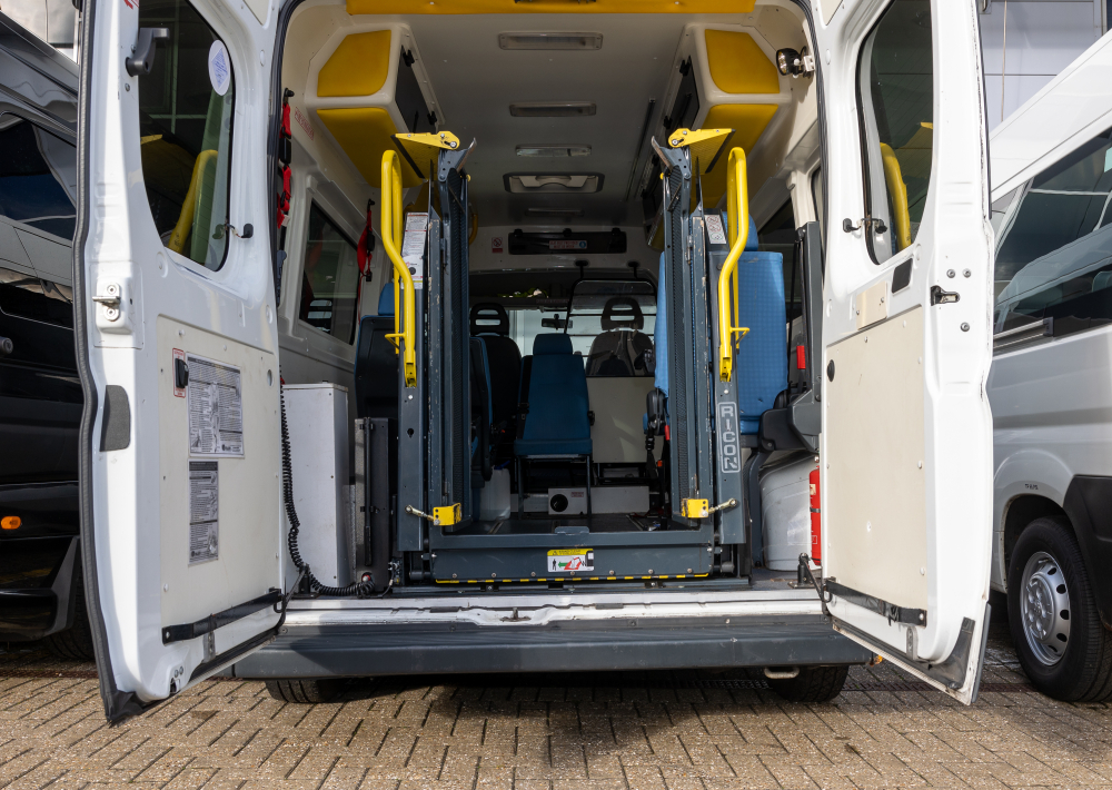 Interior of an accessible minibus showing wheelchair restraints and passenger seating